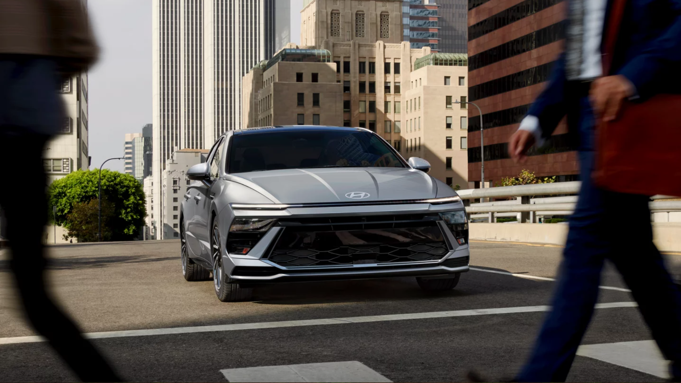 2025 Hyundai Sonata stopped at a crosswalk with people walking in front of it