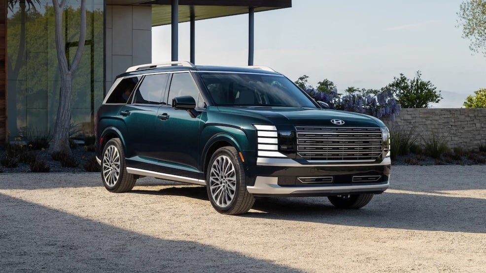 A dark green 2027 Hyundai Palisade SUV parked on a patio