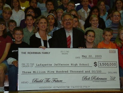 staff holding donation check