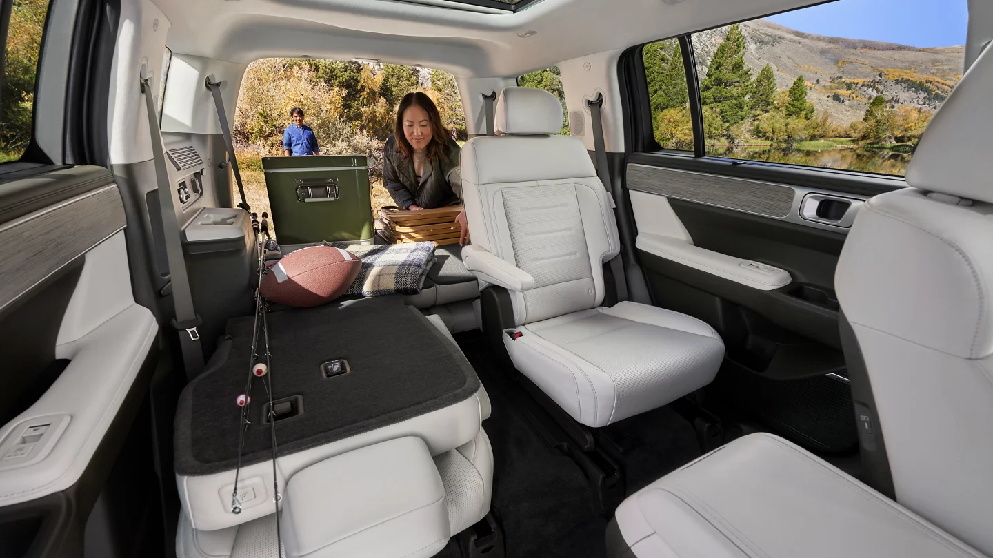 Woman placing items in the trunk of a 2025 Hyundai Santa Fe